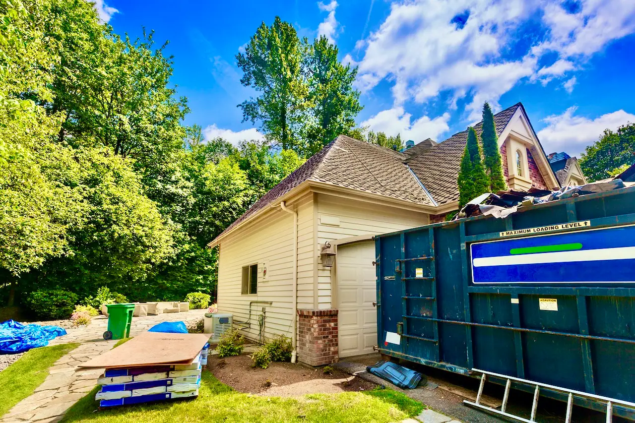 Residential construction site with a rented dumpster.