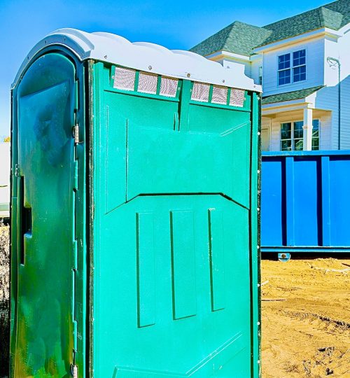 Portable bio toilet cabins at the construction on removal of debris construction waste building demolition with rock and concrete rubble
