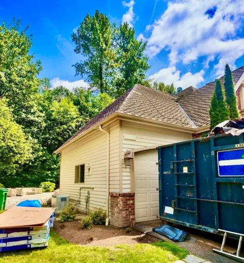 Residential construction site with a rented dumpster.